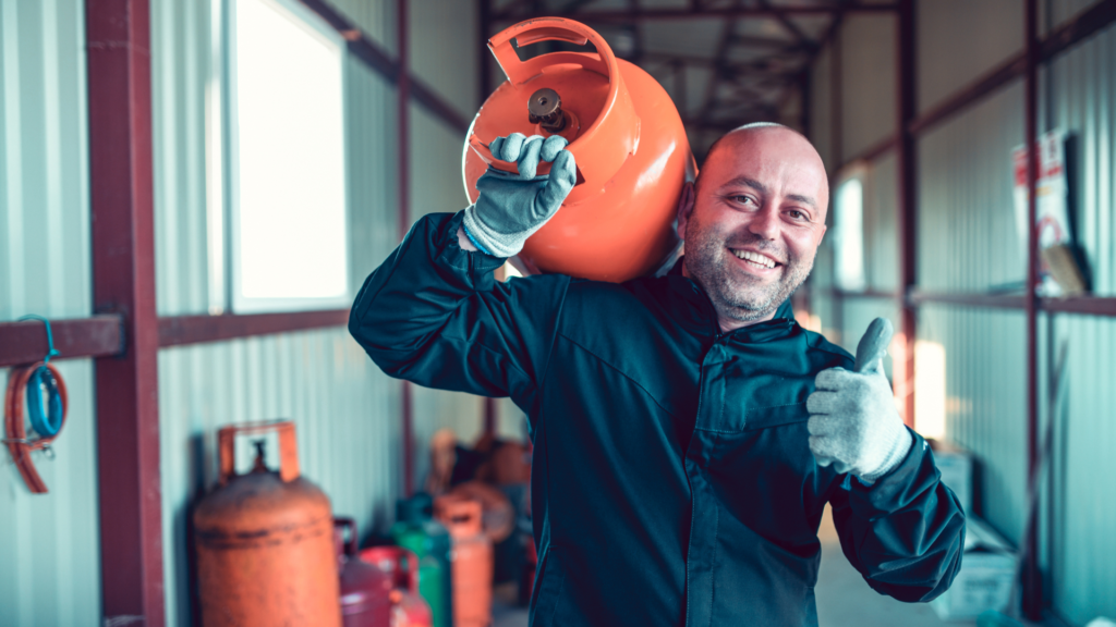 LPG gas refill being done by a man smiling
